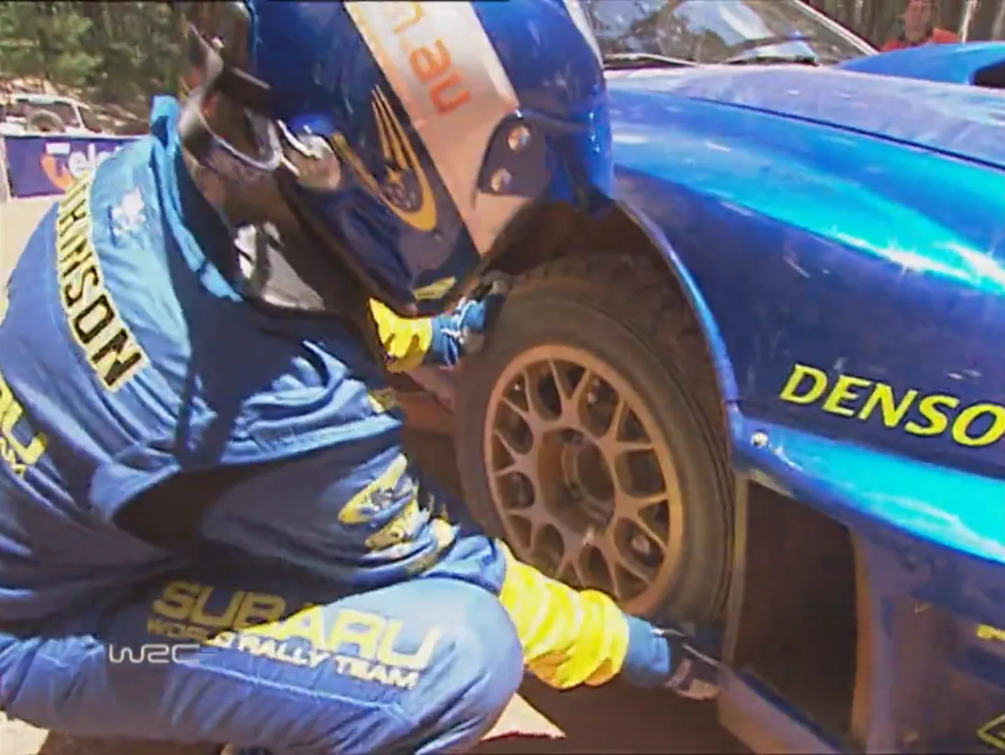 Chris Atkinson assessing the damage to his front right wheel at the stop line
